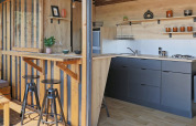 Contemporary kitchenette and bar inside Arizona safari tent at Huttopia Vallée du Lot in France.