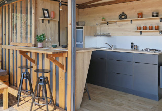 Contemporary kitchenette and bar inside Arizona safari tent at Huttopia Vallée du Lot in France.