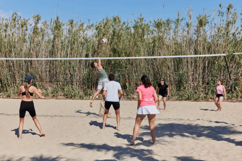 Mensen spelen beachvolleybal in TAIGA Delta de l'Ebre vakantiepark in Catalonië, Spanje op een zonnige dag.