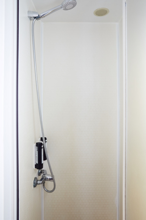 Douche dans la salle de bain minimaliste du Bungalow Essential Flamenc à TAIGA Delta de l'Ebre, Espagne.