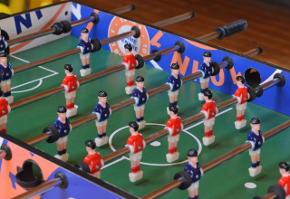 Calcio balilla al Drau Camping Sachsenburg, villaggio vacanze in Carinzia, Austria, con giocatori rossi e blu.