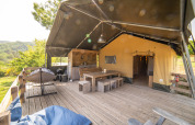 Safari Lodge tent with private bathroom and spacious wooden deck at Camping Podere Sei Poorte in Italy
