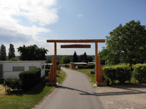 Entrance gate to Camping Belle-Vue 2000 holiday park in Echternach, Luxembourg, with caravans and greenery.