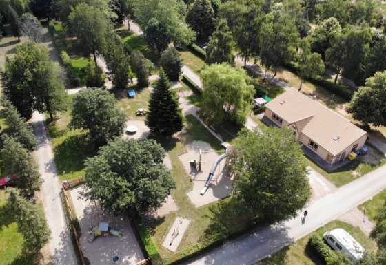 Vue aérienne du Camping Belle-Vue 2000 à Echternach, Luxembourg, montrant aires de jeux et bâtiments.