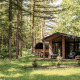 Naturlodge ved Wilsumer Berge i Tyskland med panorama sauna i skovlysning blandt høje træer.