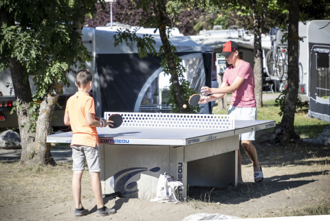 Dos personas juegan al tenis de mesa al aire libre en Huttopia Bourg Saint-Maurice, Auvernia-Ródano-Alpes, Francia.