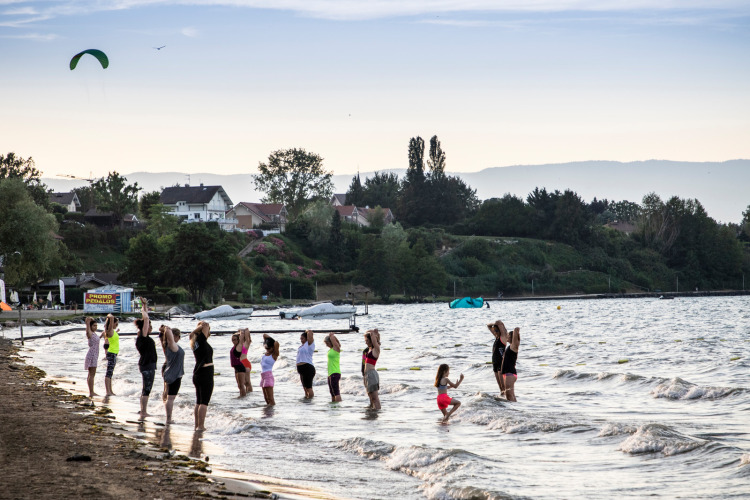 A group of people exercise in shallow water at Camping La Pinède - Excenevex in Auvergne-Rhône-Alpes, France.