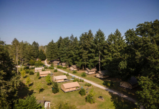 Luftfoto af Huttopia Les Châteaux feriepark med telte og skovområde i Centre-Val de Loire, Frankrig.