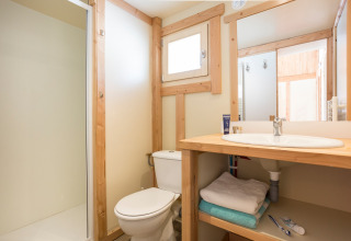 Moderne badeværelse i Chalet Montana Vista ved Huttopia la Clarée, Frankrig, med træindretning.