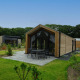 Moderne Forest Lodge med træbeklædning, store vinduer og terrasse i grøn, frodig omgivelser.