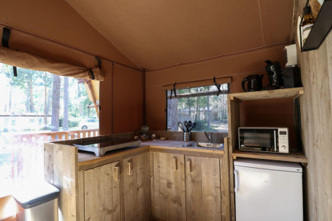 Vista interior de la cocina de una tienda safari en Lodgetent de De Zanding, Países Bajos, con electrodomésticos.