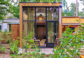 Moderne Tiny House-lodge ved De Hooge Veluwe i Holland, omgivet af natur og grøn beplantning
