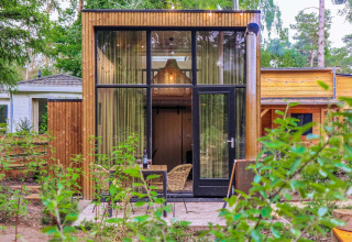 Moderne Tiny House-lodge ved De Hooge Veluwe i Holland, omgivet af natur og grøn beplantning