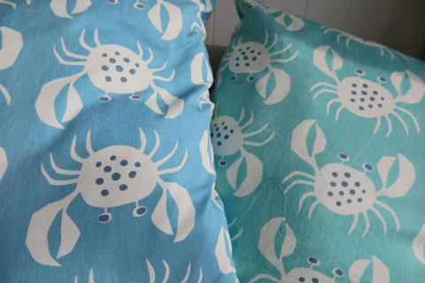 Two pillows with crab patterns rest together in a beach house in Dishoek, Zeeland, the Netherlands.
