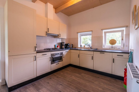Moderne keuken in een Cube-lodge bij EuroParcs Ruinen, Nederland met lichte kasten en apparatuur.