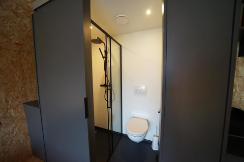 Bagno moderno al Solo Retreat di Bad Hulckesteijn, Paesi Bassi, con doccia e wc sospeso a muro.