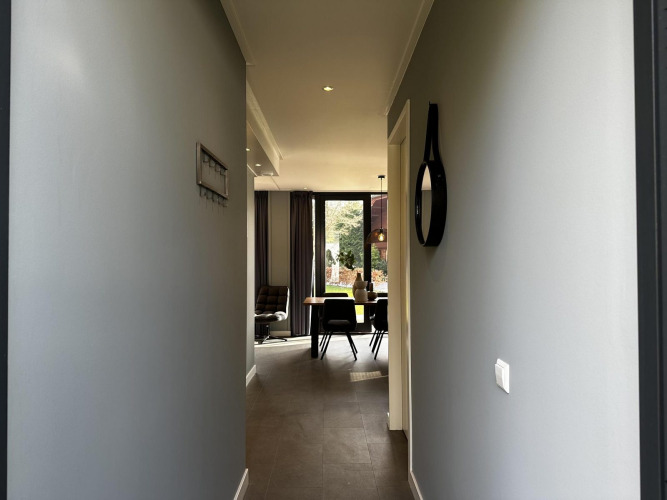 Hallway of Modus Sauna 4 lodge at De Achterhoek, Netherlands, leading to bright living and dining area.