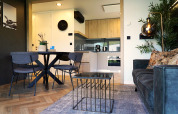 Modern lodge living room and kitchen at Domus in Kaatsheuvel, Netherlands, with stylish minimalist decor.