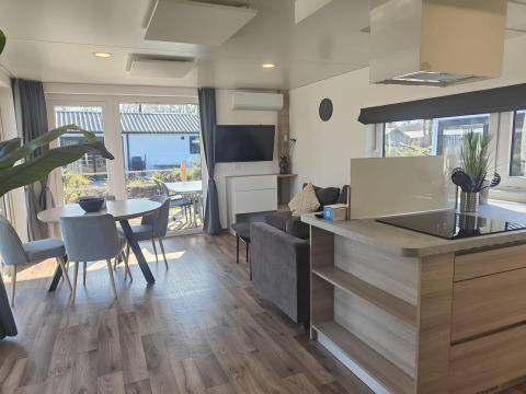 Modern lodge interior at Domus, Kaatsheuvel, Netherlands featuring living, dining, and kitchen areas.