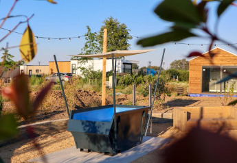 Outdoor area at Tiny House 4 at Marina Strandbad, Netherlands, with garden, patio space and modern home.
