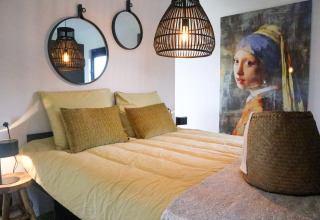 Dormitorio en Wellness Lodge 2, Marina Strandbad, Países Bajos, con decoración moderna y famosa obra de arte.
