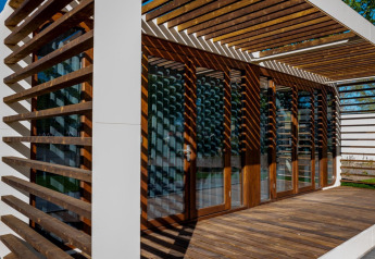 Sunny wooden slats and terrace decking at the Modus 4 lodge at Marina Strandbad, Netherlands.