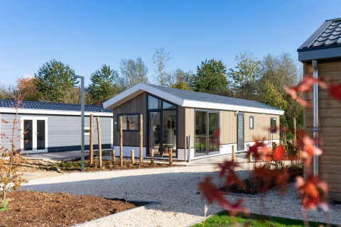 Lodge moderne Velthorst 4 à De Kraaijenbergse Plassen, Pays-Bas, entouré de verdure et ciel bleu.