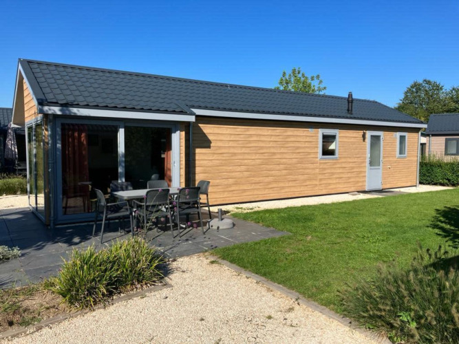 Lodge Velthorst 4 en De Kraaijenbergse Plassen, Países Bajos, con patio, mesa y sillas al aire libre.