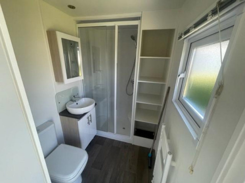 Modern bathroom with shower, sink, toilet, window, and shelving in Berkel 6 lodge at Zuiderzee, Netherlands.