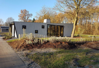 Modern tiny house Just Nature 4 bij Zuiderzee in Nederland, omringd door bomen en natuur.