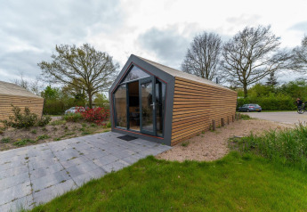 Buitenaanzicht van Solo Retreat 4 lodge bij Zuiderzee in Nederland met een moderne houten gevel.