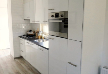 Moderna cucina bianca presso la lodge Velthorst 4 a Zuiderzee, Paesi Bassi, con forno integrato.