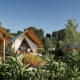 Glamping-indkvartering med luksustelte omgivet af grønne planter, træer og natur under en klar himmel.