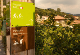 Signpost at Camping Al Lago di Lago, Veneto, Italy, showing directions to Nogarolo and panorama view.