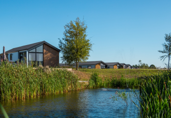 Modern tiny house Berkel at The IJssel Islands in the Netherlands, with water, nature and blue sky.