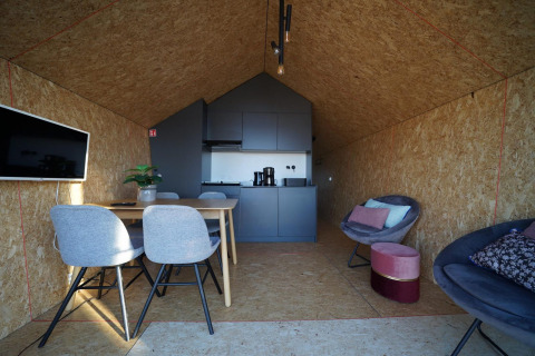 Interior view of Solo Retreat lodge at The IJssel Islands in the Netherlands with modern kitchen area.