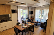 Modern Belsano lodge at Poort van Maastricht, Netherlands with open kitchen, dining table, and bright living room.