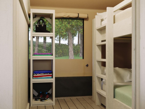 Interieur van een safaritent bij Ranger Lodge, Veluwepark de Bosgraaf in Nederland met bed en kast.