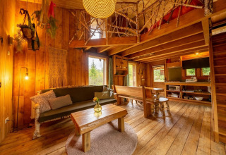 Accogliente soggiorno della Nature Lodge a De Wije Werelt, Paesi Bassi, con arredi rustici in legno.