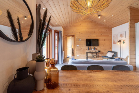 Interiør på lodge Boekhorst, Brunssummerheide, Holland, med træpaneler og moderne møbler.