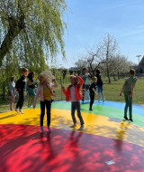 Children are jumping and playing on a colorful air cushion at FarmCamps De Buitenhoeve in Gelderland, Netherlands.