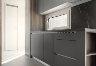 Moderne minimalistische keuken in Silvanus lodge bij Kohnenhof, Luxemburg, met grijze kasten en raam.