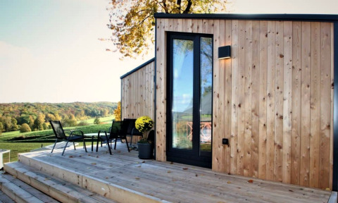 Outdoor deck at Panorama Cottage with modern wood paneling and scenic views of the rolling countryside.