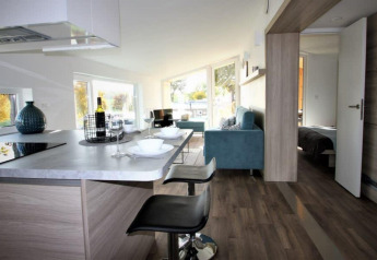 Interior moderno de Panorama Cottage en Gulperberg, Países Bajos, con cocina, sala y dormitorio al fondo.