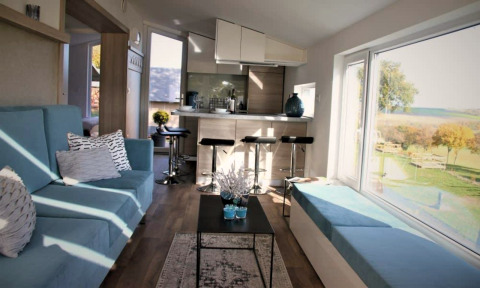 Interior of Panorama Cottage at Gulperberg, Netherlands, with modern decor and large scenic windows.
