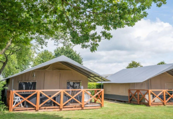 Panorama Lodge at Gulperberg in the Netherlands, featuring spacious glamping tents and wooden terraces.