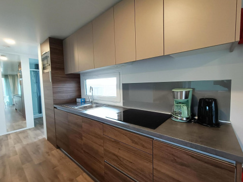Cucina moderna al Berghem at Gulperberg lodge nei Paesi Bassi con elettrodomestici e finiture in legno.