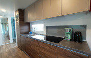 Cucina moderna al Berghem at Gulperberg lodge nei Paesi Bassi con elettrodomestici e finiture in legno.