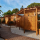 Udendørs billede af træbungalows ved Bungalow Premium Levante med terrasse og grønne planter under blå himmel.