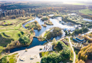 Aerial view of Netl Camping Kallumaan, a holiday park with lakes, green areas and buildings in Flevoland.
